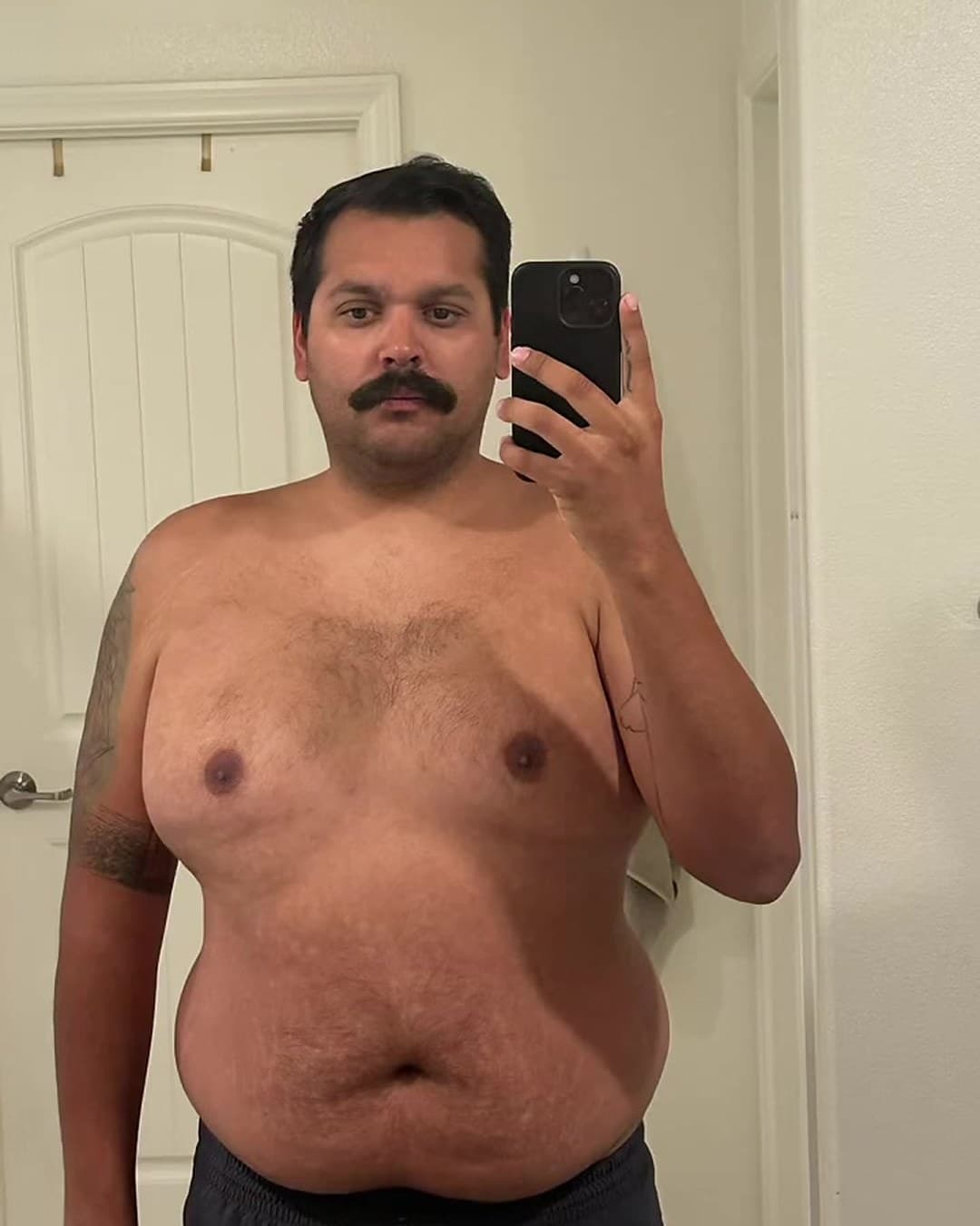 Before: Kody shirtless in a bathroom mirror selfie at about 300 pounds, 2024.